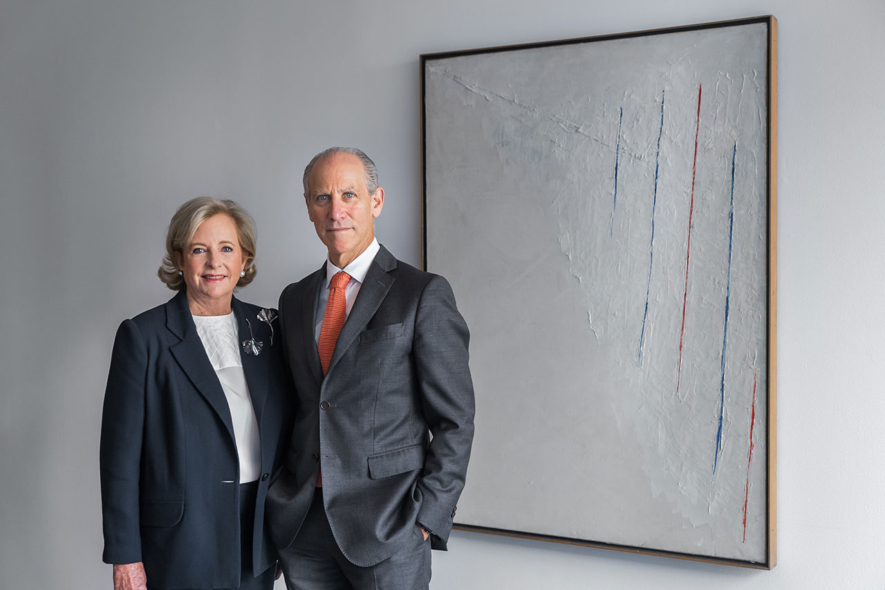 Patricia Phelps de Cisneros and Glenn Lowry with an Alejandro Otero, 'Colored Lines on White Background,' 1950. Courtesy of MoMA.