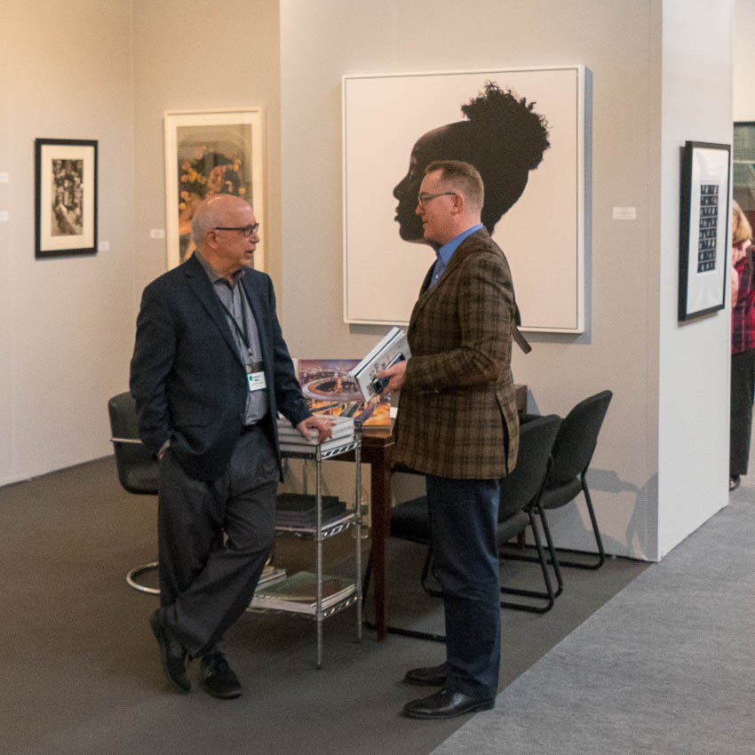 Laurence Miller talking to a collector at AIPAD